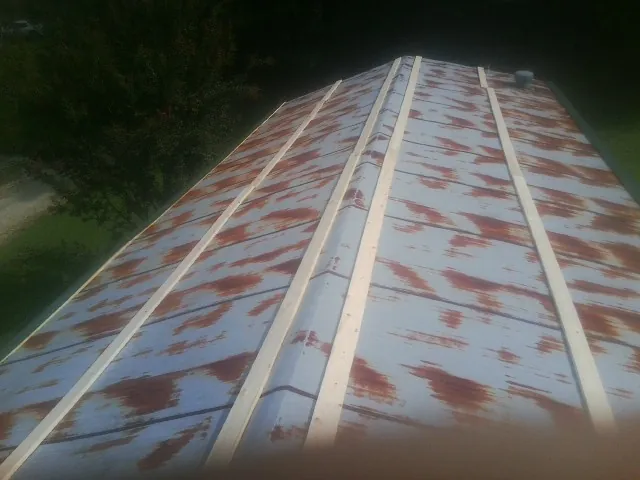 Rusted metal roof panels with new wood purlins before replacement — Storm Damage Roof Repair in Greenbrae by Roofing Brothers