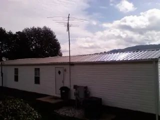 New metal roof on a single wide mobile home with a TV antenna in Greenbrae