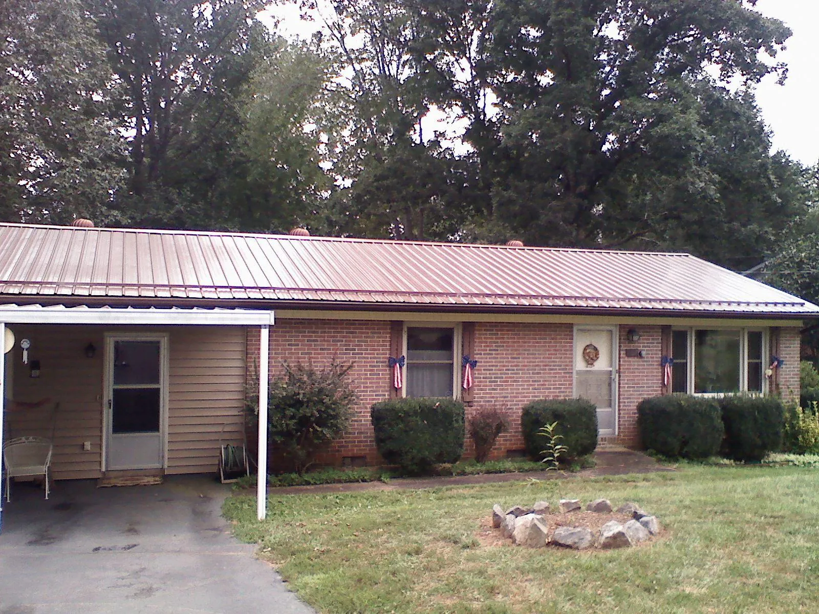 Bronze metal roof and carport on a brick ranch home — Roof Repair work by our crew in Greenbrae